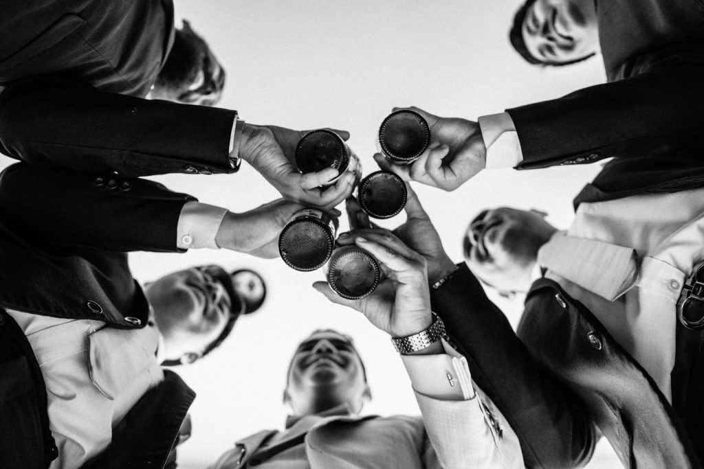 Group of friends raising beers in a toast